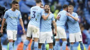 Manchester City's Sergio Aguero, centre, celebrates with teammates after scoring during the English Premier League soccer match between Manchester City and Everton at the Etihad stadium in Manchester, Sunday, May 23