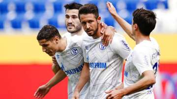 Schalke's scorer Mark Uth, second right, and his teammates celebrate a goal. 