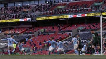 Manchester City's Aymeric Laporte, center, celebrates after scoring the opening goal during the English League Cup final soccer match between Manchester City and Tottenham Hotspur at Wembley stadium in London, Sunday, April 25, 2021