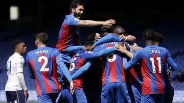 Crystal Palace's Tyrick Mitchell,obscured, is congratulated by teammates after scoring his team's third goal during the English Premier League soccer match between Crystal Palace and Aston Villa at Selhurst Park in London, Sunday, May 16