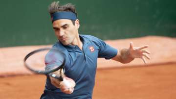 Roger Federer of Switzerland returns a ball to Pablo Andujar of Spain during their men's second round match, at the ATP 250 Geneva Open tournament in Geneva, Switzerland, Tuesday, May 18,