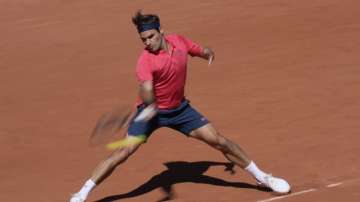 Switzerland's Roger Federer plays a return to Uzbekistan's Denis Istomin during their first round match on day two of the French Open tennis tournament at Roland Garros in Paris, France, Monday, May 31