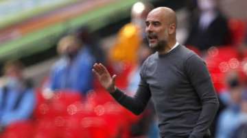 Manchester City's head coach Pep Guardiola gestures during the English League Cup final soccer match between Manchester City and Tottenham Hotspur at Wembley stadium in London, Sunday, April 25