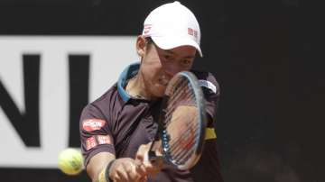 Japan's Kei Nishikori returns the ball to Italy's Fabio Fognini during their match at the Italian Open tennis tournament, in Rome, Monday, May 10