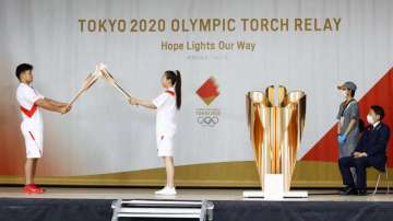 An ignition ceremony for the Tokyo Olympic torch relay is held at Heiwadai Athletic Stadium in Fukuoka, southwestern Japan, Tuesday, May 11
