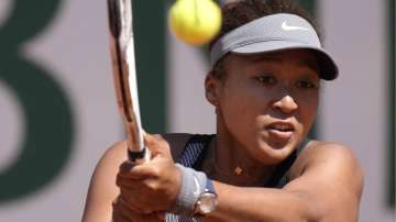 Japan's Naomi Osaka returns the ball to Romania's Patricia Maria Tig during their first round match of the French open tennis tournament at the Roland Garros stadium Sunday, May 30