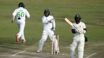 Pakistan wicketkeeper Mohammad Rizwan, centre, celebrates the wicket of Zimbabwe batsman Regis Chakabva during the second test cricket match against Zimbabwe at Harare Sports Club, Sunday, May, 9