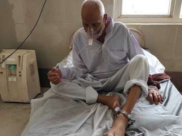 In picture, 90-year-old prisoner chained during treatment in Etah