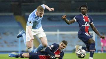 PSG's Marco Verratti, center, and PSG's Moise Kean, right, challenge Manchester City's Kevin De Bruyne during the Champions League semifinal second leg soccer match between Manchester City and Paris Saint Germain at the Etihad stadium, in Manchester, Tuesday, May 4