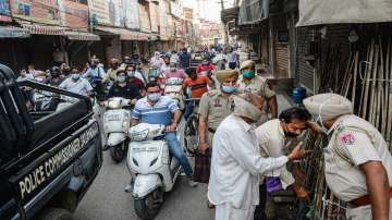 Police force shopkeepers to close shops during the start of lockdown imposed by Punjab State government to curb the spread of coronavirus cases.