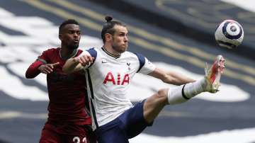 Tottenham's Gareth Bale, right, and Wolverhampton Wanderers' Nelson Semedo challenge for the ball during the English Premier League soccer match between Tottenham Hotspur and Wolverhampton Wanderers at Tottenham Hotspur Stadium in London, England, Sunday, May 16