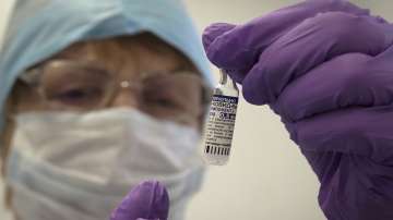 A medical worker prepares a shot of Russias Sputnik V coronavirus vaccine in a local rural medical post in the village of Ikhala in Russia.