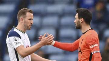 Tottenham's Harry Kane, left, shakes hands with Tottenham's goalkeeper Hugo Lloris at the end of the English Premier League soccer match between Leicester City and Tottenham Hotspur at the King Power Stadium, in Leicester, England, Sunday, May 23