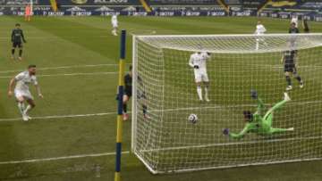 Leeds United's Stuart Dallas, left, scores his team's first goal during the English Premier League soccer match between Leeds United and Tottenham Hotspur at Elland Road in Leeds, England, Saturday, May 8