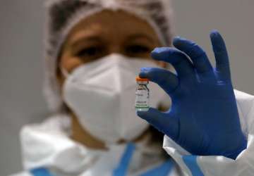 FILE - In this Tuesday, Jan. 19, 2021 file photo, a medical worker poses with a vial of the Sinopharm's COVID-19 vaccine in Belgrade, Serbia 