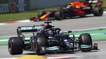 Mercedes driver Lewis Hamilton of Britain takes a curve followed by Red Bull driver Max Verstappen of the Netherlands, in the background, during the third free practice for the Spanish Formula One Grand Prix at the Barcelona Catalunya racetrack in Montmelo, just outside Barcelona, Spain, Saturday, May 8
