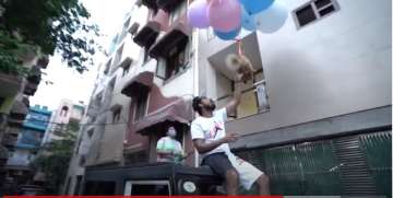 The dog is strapped to a bunch of balloons and is set loose to fly