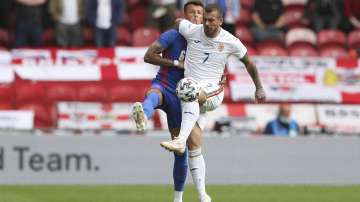 England's Ben White, left, challenges for the ball with Romania's Denis ALibec during the international friendly soccer match between England and Romania in Middlesbrough, England, Sunday, June 6