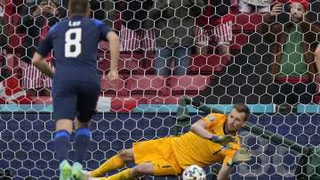 Finland's goalkeeper Lukas Hradecky makes a save during the Euro 2020 soccer championship group B match between Denmark and Finland at Parken stadium in Copenhagen, Saturday, June 12