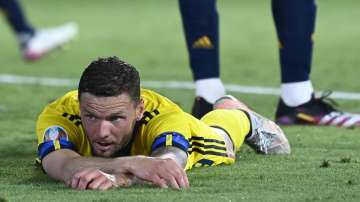 Sweden's Marcus Berg lies on the pitch during the Euro 2020 soccer championship group E match between Spain and Sweden at La Cartuja stadium in Seville, Monday, June 14