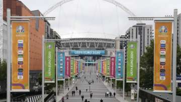 People walk the road to Wembley stadium during the Euro 2020 soccer championship in London, Thursday, June 17