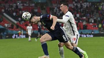 Scotland's Kieran Tierney, left, and England's Mason Mount challenge for the ball during the Euro 2020 soccer championship group D match between England and Scotland at Wembley stadium in London, Friday, June 18