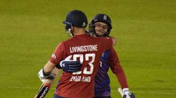 England's Sam Curran, right, hugs teammate England's Liam Livingstone, after defeating Sir Lanka in the second T20 international cricket match between England and Sri Lanka in Cardiff, Wales, Thursday, June 24