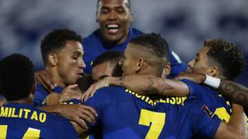 Players of Brazil celebrate their side's opening goal scored by teammate Neymar during a qualifying soccer match for the FIFA World Cup Qatar 2022 against Paraguay at Defensores del Chaco stadium in Asuncion, Paraguay, Tuesday, June 8