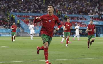 Portugal's Cristiano Ronaldo celebrates after scoring his side's second goal during the Euro 2020 soccer championship group F match between Portugal and France at the Puskas Arena in Budapest, Wednesday, June 23