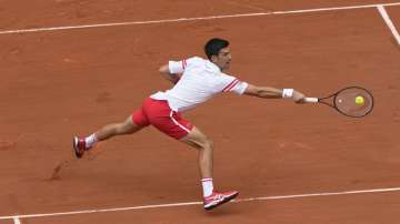 Serbia's Novak Djokovic plays a return to Italy's Lorenzo Musetti during their fourth round match on day 9, of the French Open tennis tournament at Roland Garros in Paris, France, Monday, June 7