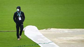 Devon Conway of New Zealand walks across the outfield as play is delayed on Day 4 of the ICC World Test Championship Final between India and New Zealand at The Hampshire Bowl on June 21
