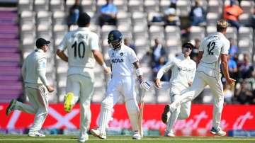 Virat Kohli of India walks off as Kyle Jamieson of New Zealand celebrates his wicket during the Reserve Day of the ICC World Test Championship Final between India and New Zealand at The Hampshire Bowl on June 23
