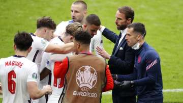 Gareth Southgate, Head Coach of England speaks with his players after their side's first goal scored by Raheem Sterling of England (obscured) during the UEFA Euro 2020 Championship Round of 16 match between England and Germany at Wembley Stadium on June 29