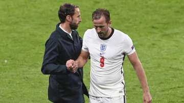 England's Harry Kane, right, shakes hands with his coach Gareth Southgate as he leaves the pitch during the Euro 2020 soccer championship group D match between England and Scotland, at Wembley stadium, in London, Friday, June 18