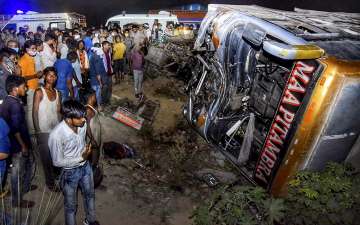  Crowd gathers near the site where a bus collided with a tempo truck, late night in Kanpur, Tuesday June 8, 2021