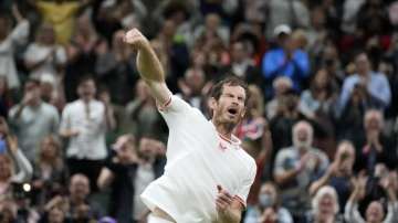 Britain's Andy Murray celebrates winning the men's singles match against Georgia's Nikoloz Basilashvili on day one of the Wimbledon Tennis Championships in London, Monday June 28