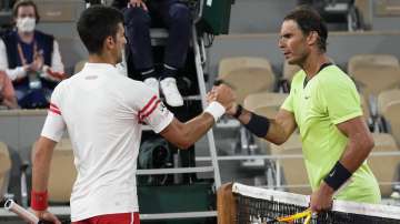 Serbia's Novak Djokovic, left, shakes hands with Spain's Rafael Nadal after their semifinal match of the French Open tennis tournament at the Roland Garros stadium Friday, June 11