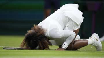 Serena Williams of the US falls to the ground during the women's singles first round match against Aliaksandra Sasnovich of Belarus on day two of the Wimbledon Tennis Championships in London, Tuesday June 29