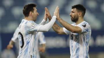 Argentina's Lionel Messi, left, celebrates scoring his side's second goal from the penalty spot with teammate Sergio Aguero during a Copa America soccer match against Bolivia at Arena Pantanal stadium in Cuiaba, Brazil, Monday, June 28