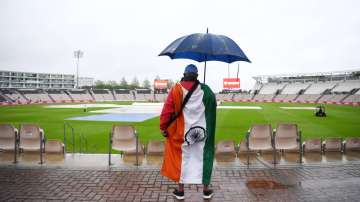 A India fan looks on as play is delayed on Day 1 of the ICC World Test Championship Final between India and New Zealand at The Hampshire Bowl on June 18, 2021 in Southampton, England