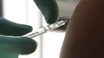 A young woman gets vaccinated with the Johnson & Johnson vaccine at the Revolte bar in Berlin's Friedrichshain district.