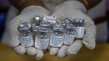 A health worker displays vials of COVID-19 vaccines in Guwahati.