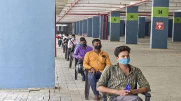 Beneficiaries wait to receive the COVID-19 vaccine dose at a vaccination camp set up by the UP Government, at Gaur Mall in Greater Noida (W).