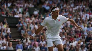 Switzerland's Roger Federer plays a return to Richard Gasquet of France during the men's singles second round match on day four of the Wimbledon Tennis Championships in London, Thursday July 1
