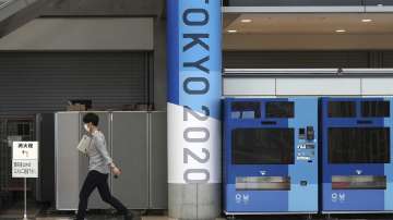 A man wearing a protective mask to help curb the spread of the coronavirus walks at pre-opened Main Press Center (MPC) for Tokyo 2020 Olympic Games at Tokyo Big Site Friday, July 2