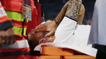 Italy's Leonardo Spinazzola covers his face after injuring during the Euro 2020 soccer championship quarterfinal match between Belgium and Italy at at the Allianz Arena in Munich, Germany, Friday, July 2