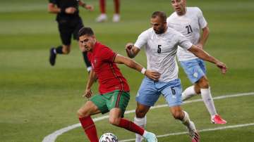 In this June 9, 2021, file photo, Portugal's Andre Silva, left, works for the ball against Israel's Orel Dgani during an international friendly soccer match in Lisbon. Leipzig signed Silva from Bundesliga rival Eintracht Frankfurt on Friday, July 2