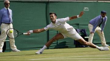 Serbia's Novak Djokovic plays a return to Denis Kudla of the US during the men's singles third round match on day five of the Wimbledon Tennis Championships in London, Friday July 2