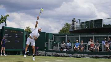 Italy's Matteo Berrettini serves to Ilya Ivashka of Belarus during the men's singles fourth round match on day seven of the Wimbledon Tennis Championships in London, Monday, July 5