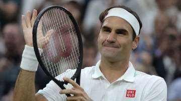 Switzerland's Roger Federer celebrates after defeating Italy's Lorenzo Sonego during the men's singles fourth round match on day seven of the Wimbledon Tennis Championships in London, Monday, July 5